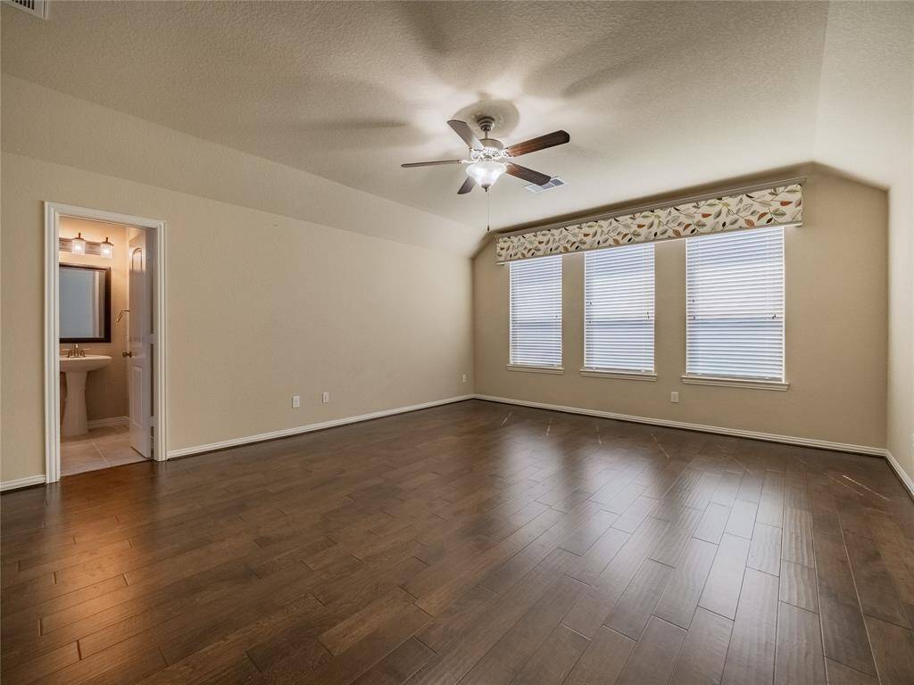 upstairs you have this wonderful game room with wooden flooring, oversized windows ceiling fan and there is a half bath