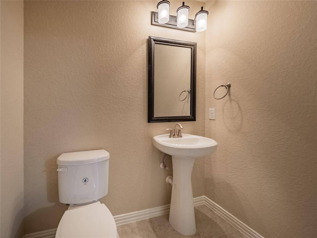 the half bath upstairs with the media room and game room