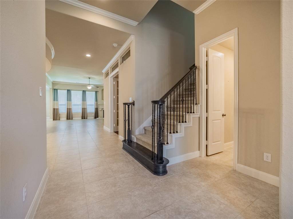 from this angle you can see the open floor plan and just past the staircase is and office with double glass door and on the left is your formal dining room with a rotunda