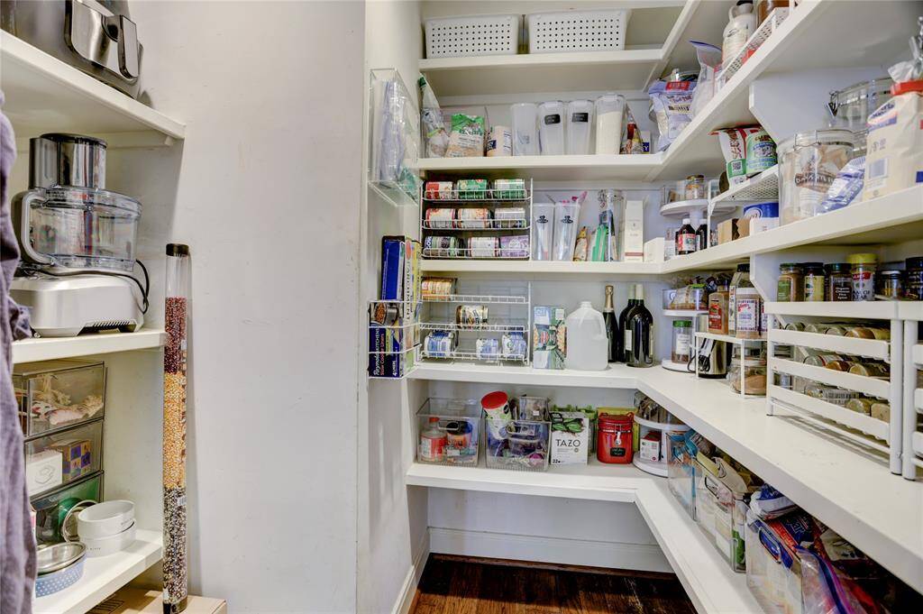 The walk-in pantry offers ample storage for food and appliances.