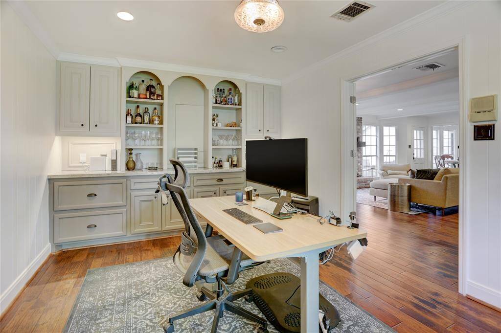 Just off the family room sits a French-door study with built-in cabinets and shelves.