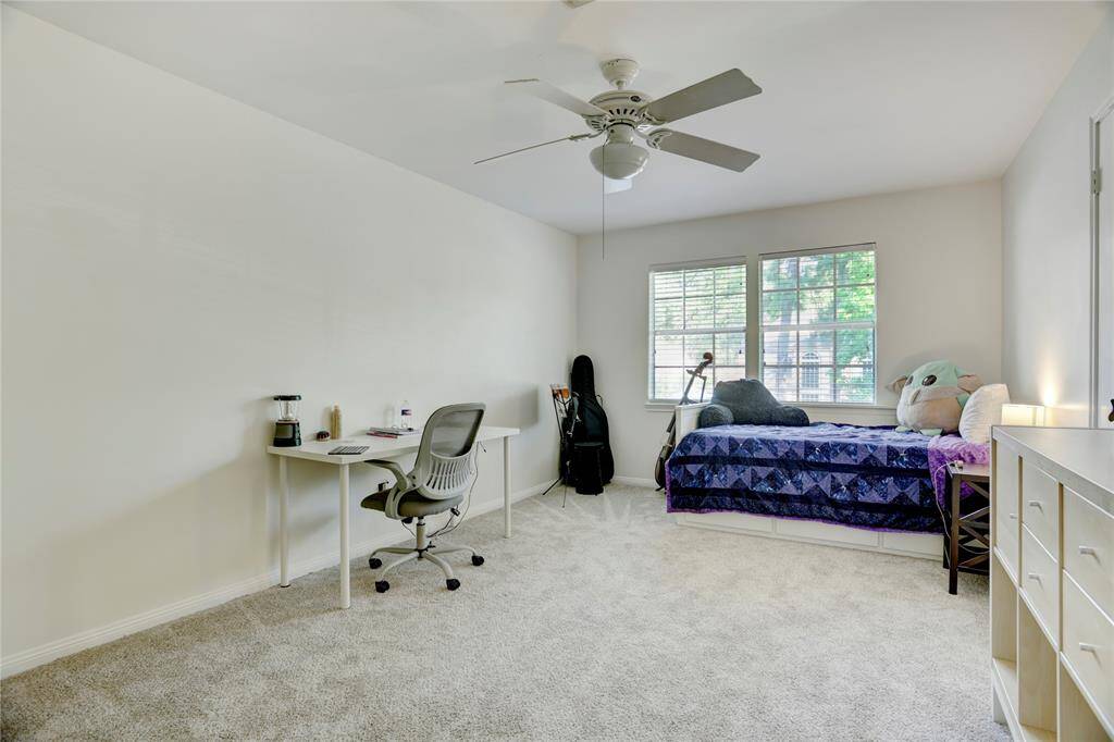 Bedroom 2 upstairs with views of the backyard and walk-in closet.