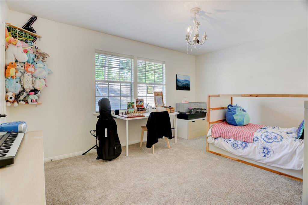Bedroom 3 upstairs, also with backyard views and a walk-in closet.