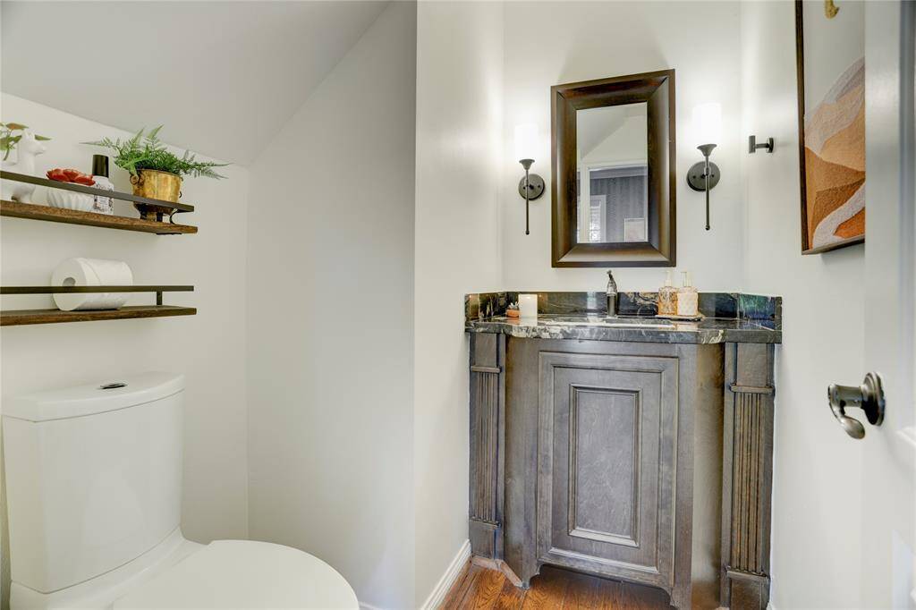 Located in the foyer and near the kitchen/dining is the powder bathroom.