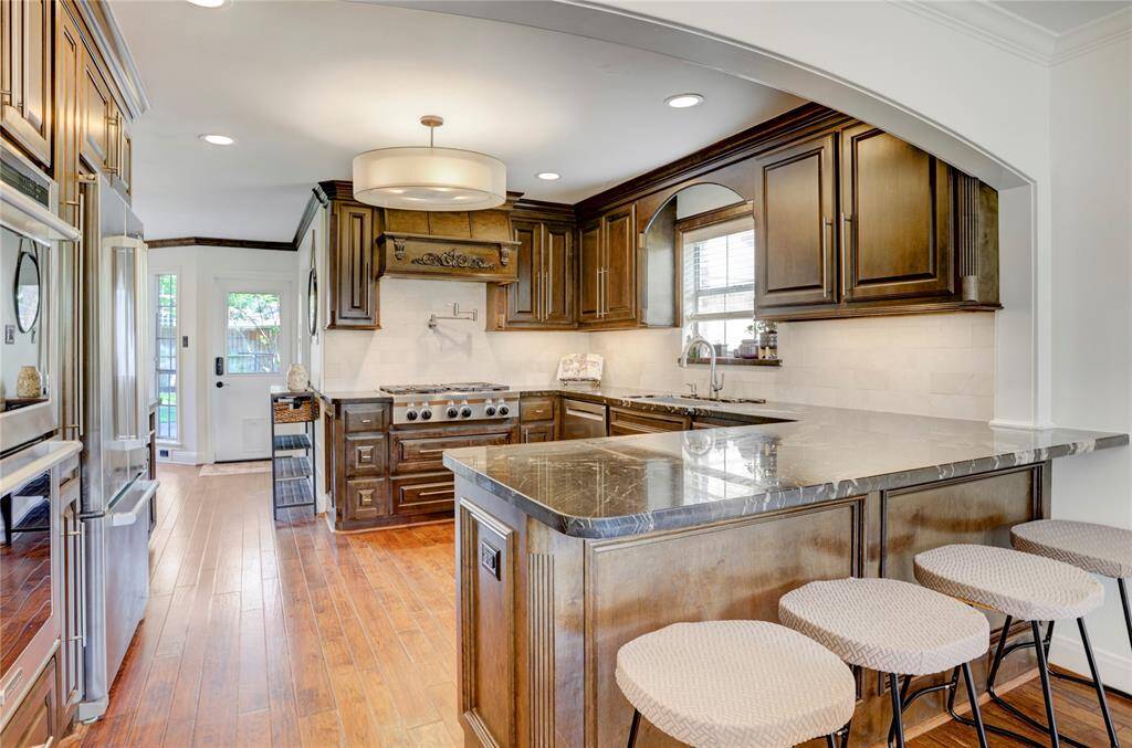 View of the kitchen from the dining room, fit with stainless steel Kitchenaid appliances.