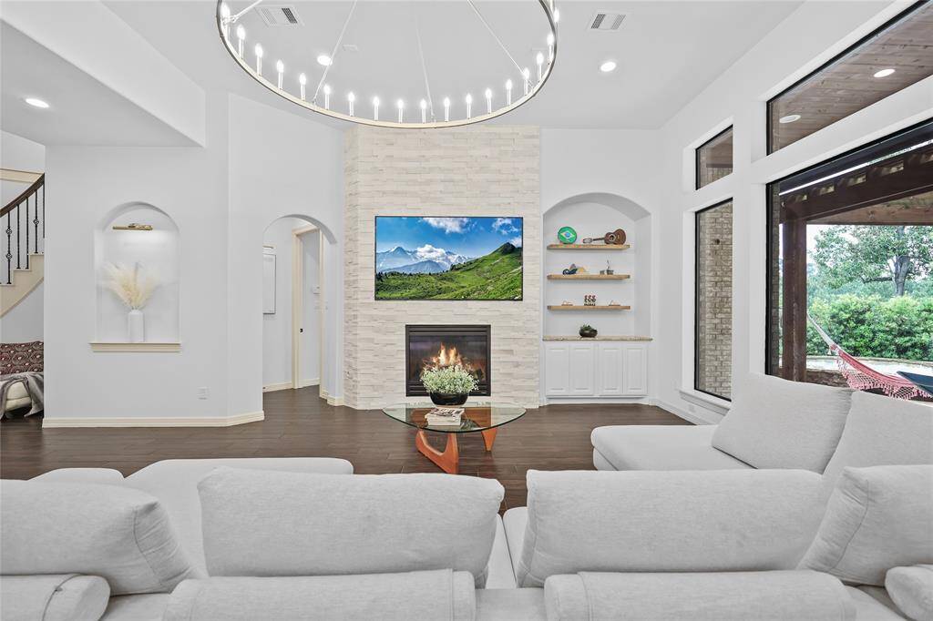 Living room with refreshed fireplace and updated light fixture.