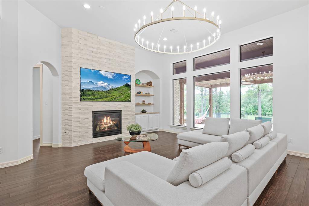 Living room with refreshed fireplace and updated light fixture.