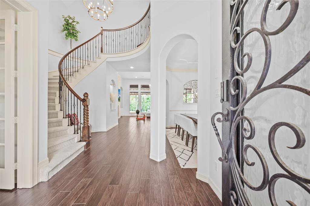 Entryway with curved staircase.