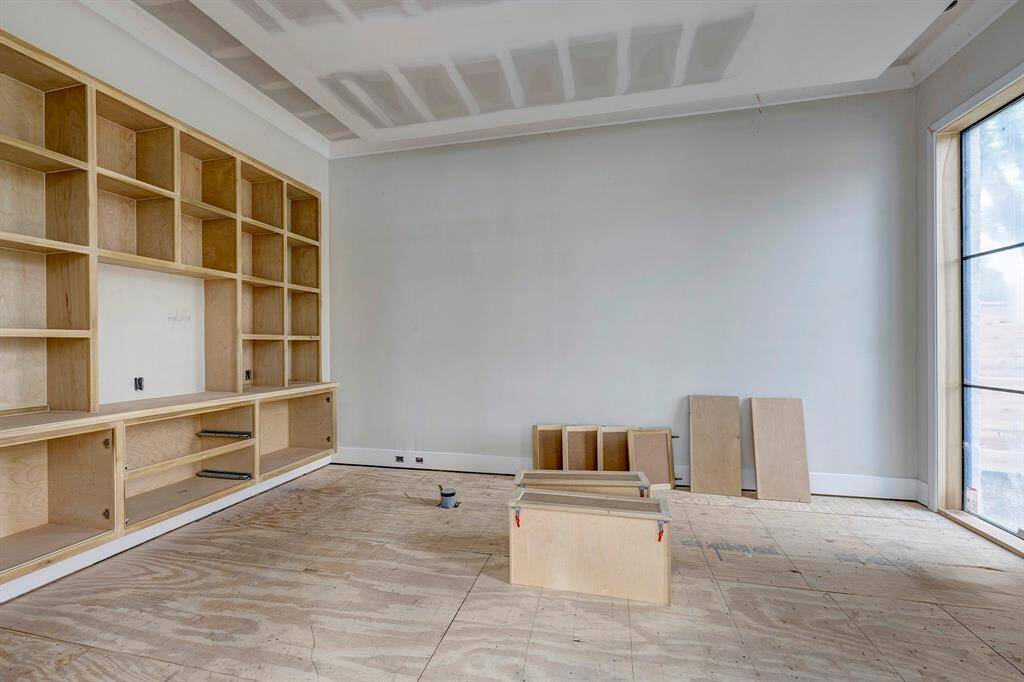 Study with built-ins off the foyer with windows overlooking front yard. Stage of construction as of April 3, 2025.