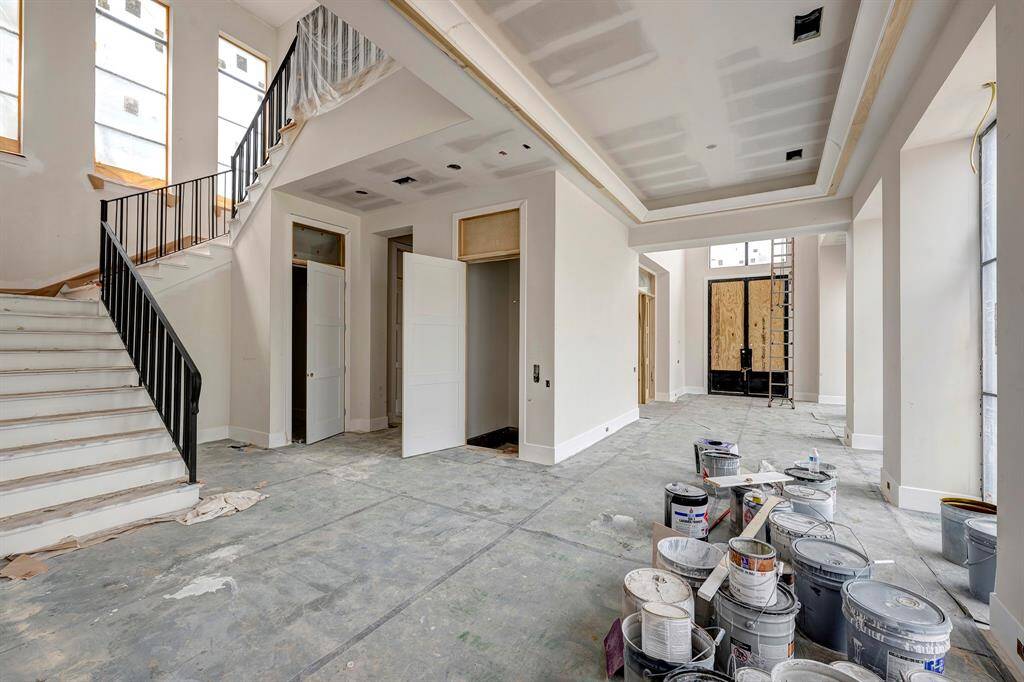 Looking towards the front entrance. Study on the left. Staircase leads to the 2nd floor. Also pictured are the coat closet and elevator. Stage of construction as of April 3, 2025.