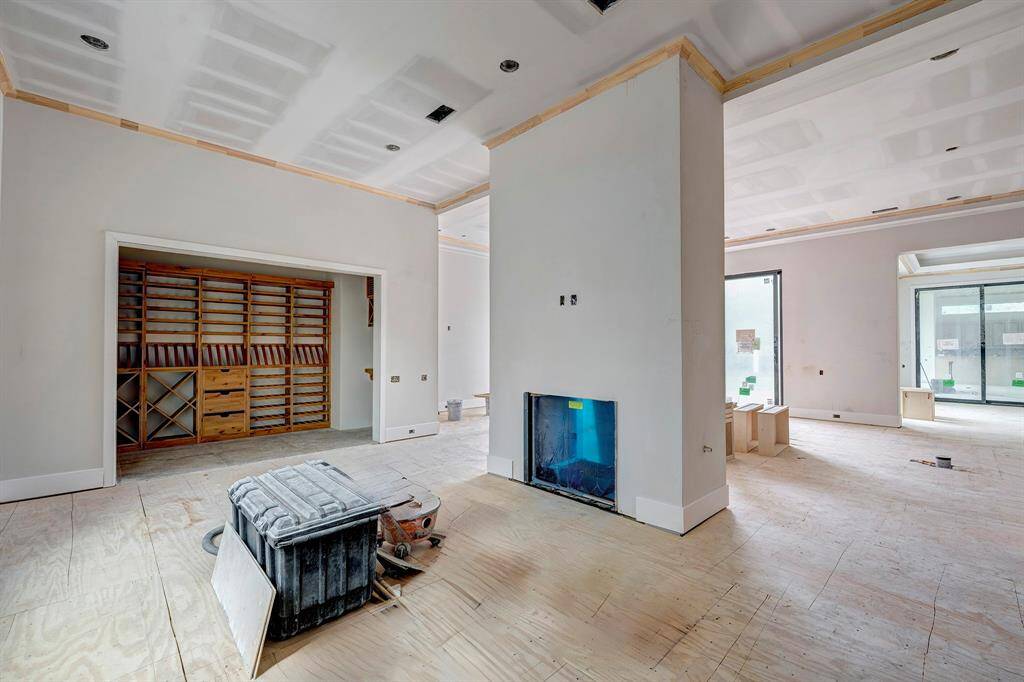 On the other side of the the two-sided fireplace is the wine room and flexible space. Not pictured is the wet bar. Stage of construction as of April 3, 2025.