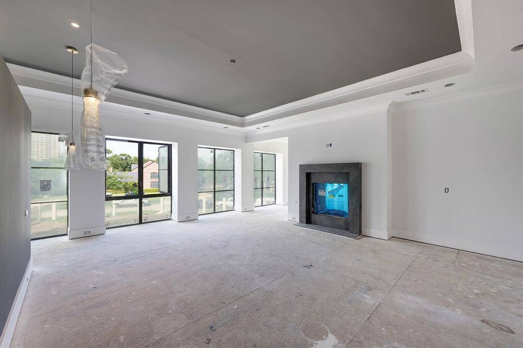Another view of the spacious primary suite looking towards the street. Stage of construction as of April 17, 2025.