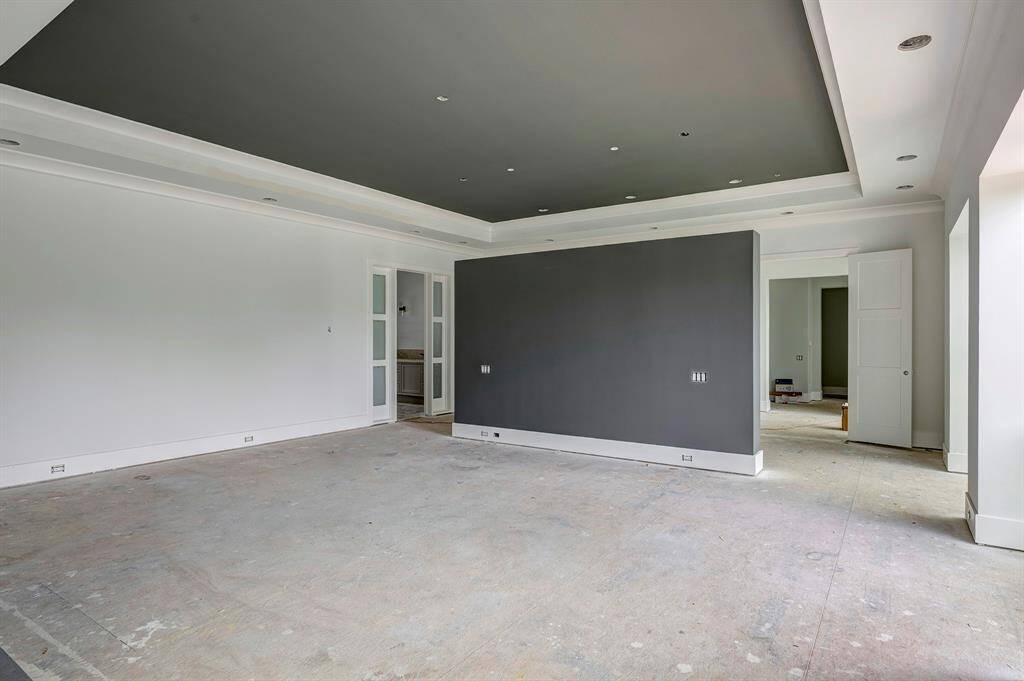 Expansive primary suite as of April 3, 2025. Entrance to primary bath and his/her closets through the door to the left.