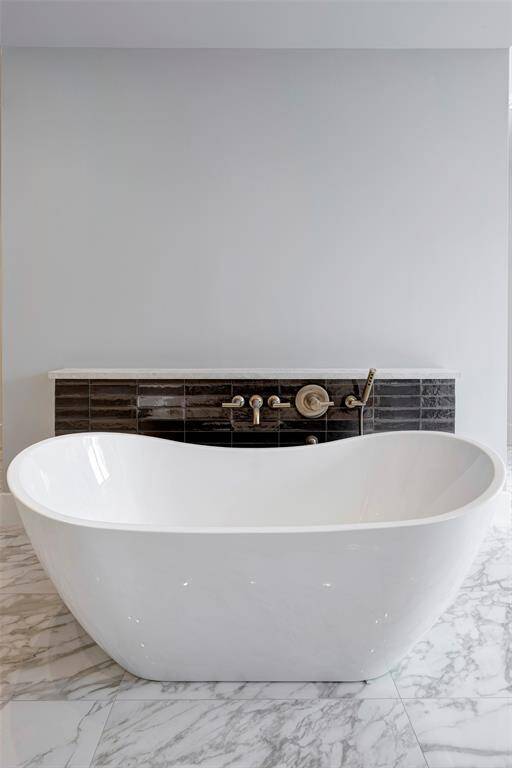 Primary bath features a luxurious soaking tub. Stage of construction as of April 17, 2025.