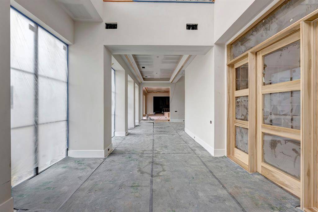 View from the front entrance into this home. Doors on the left lead to the study. Stage of construction as of April 3, 2025.