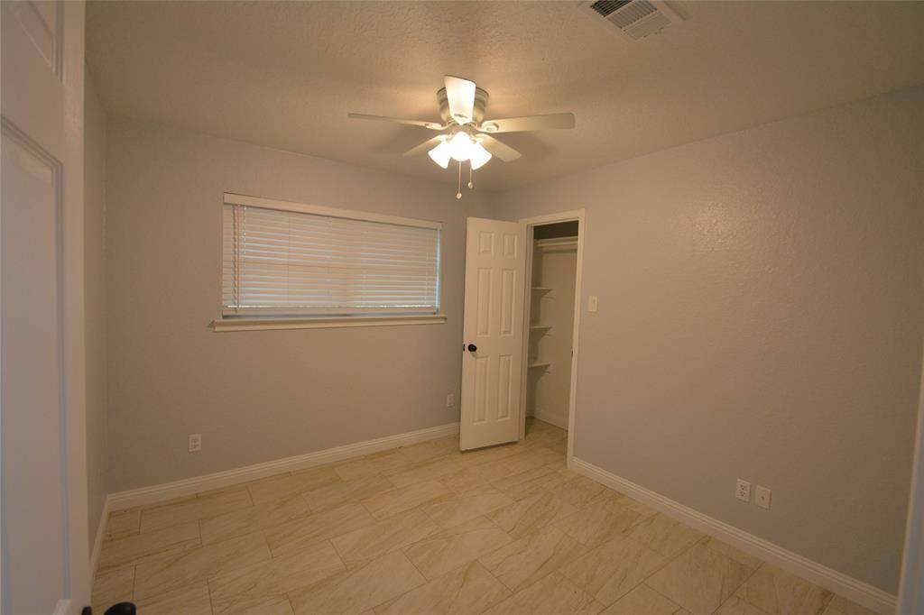 Secondary bedroom with built in shelves