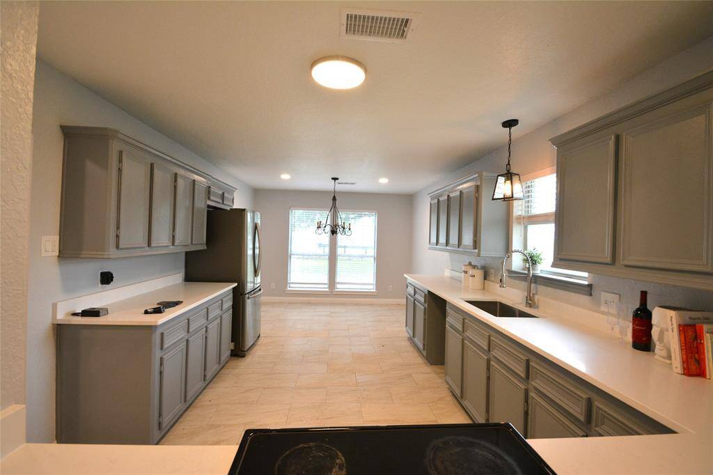 Completely modern kitchen. Appliances to stay! Deep sink, plenty of counter and cabinet space and plenty of room for a table and chairs in the dining area.