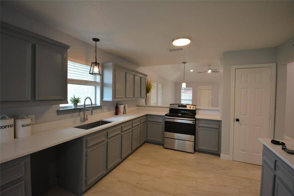 Look at this beautiful kitchen! Deep sink, solid surface countertops and nice sized pantry.