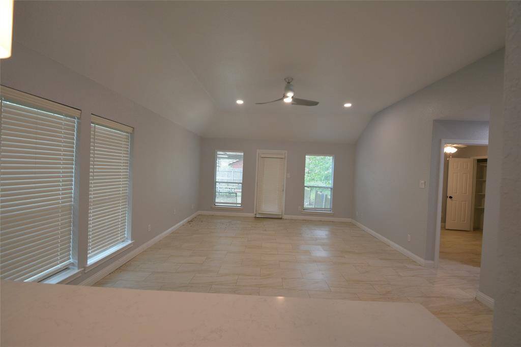Living room with vaulted ceilings. Breakfast bar for easy meals!