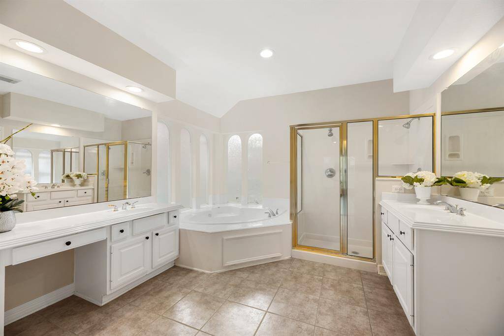 Primary bath with 2 separate sinks, separate shower and tub.
