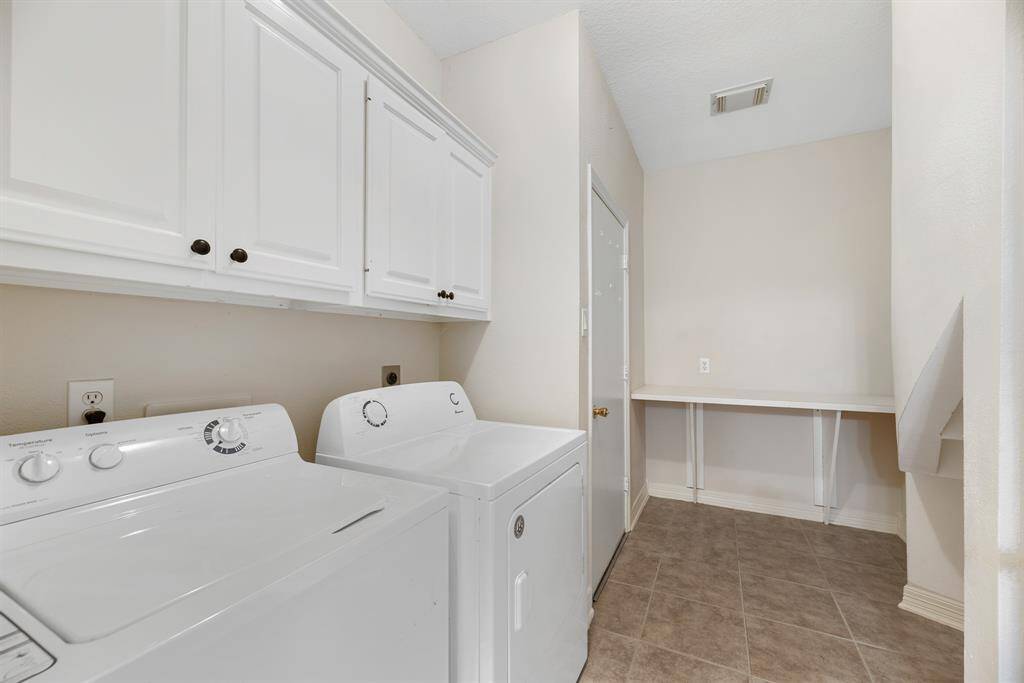 Oversized laundry room with a convenient countertop for folding clothes and/or unloading groceries from the car.
