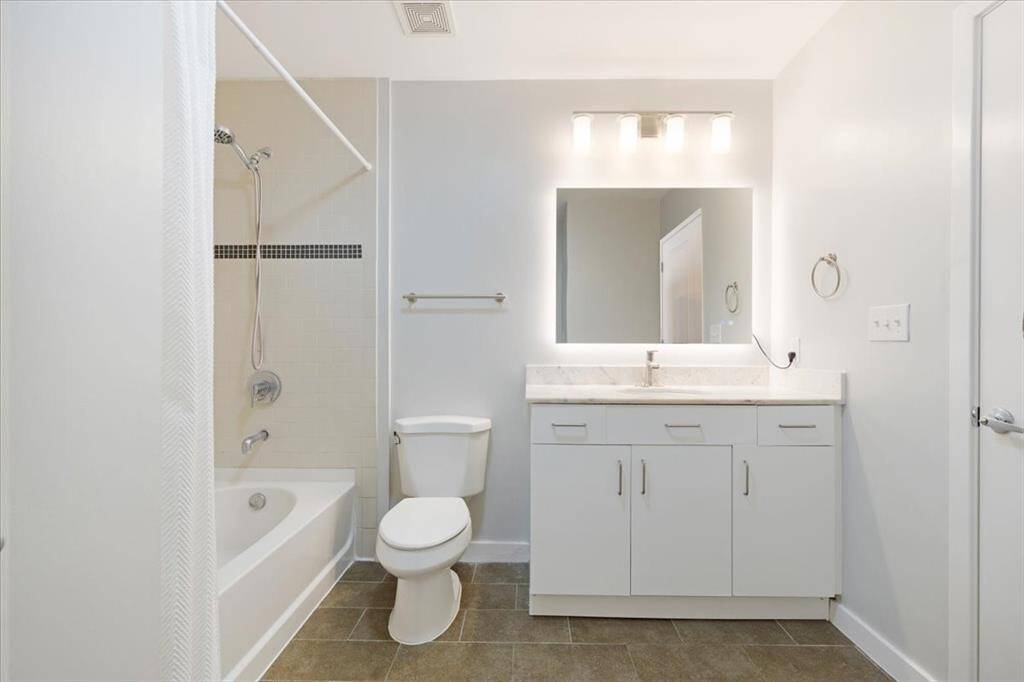 Large bathroom and full-sized washer and dryer.