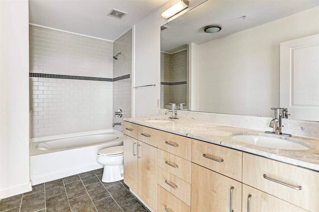 The Master Bath has double sinks, tile floor, and tub/shower combo with tile surround.