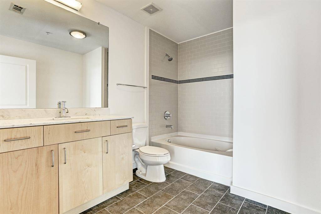 The Second Bath has tile floor and tub/shower combo with tile surround.