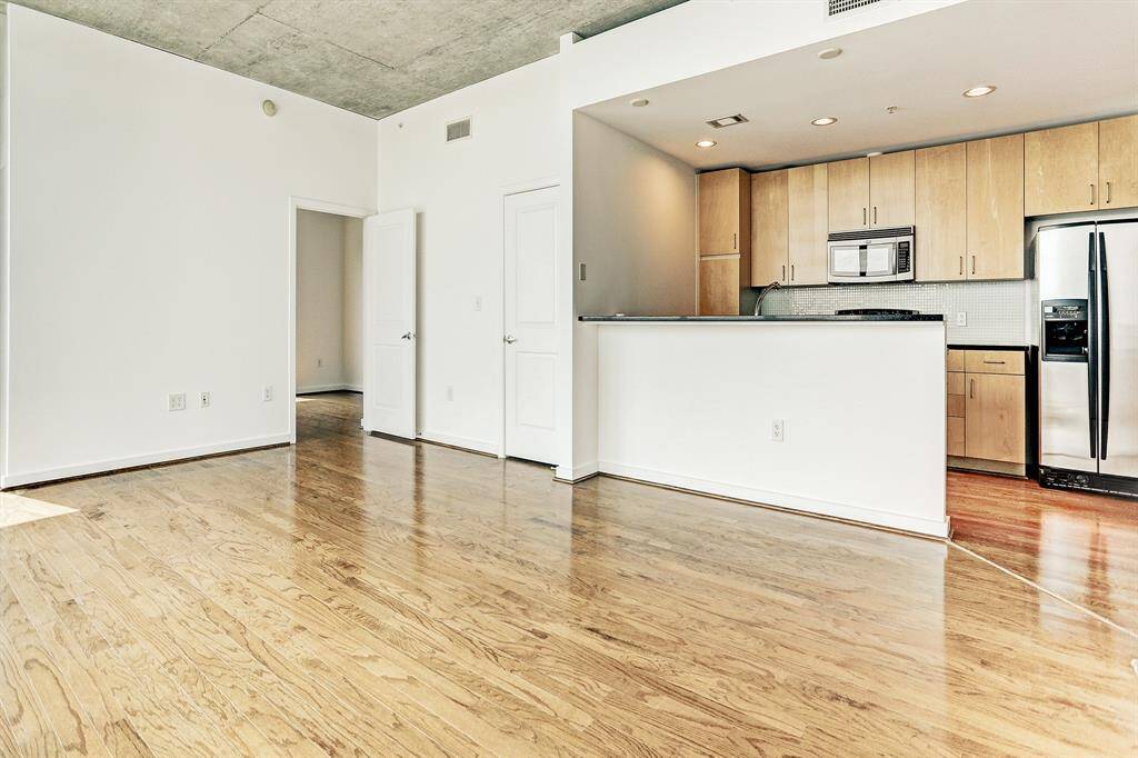 The kitchen, overlooking the living room, has a breakfast bar.