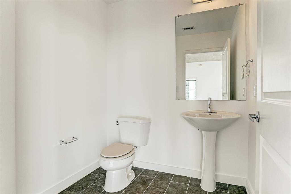 The 6x6 SF half bath has tile floor & pedestal sink.