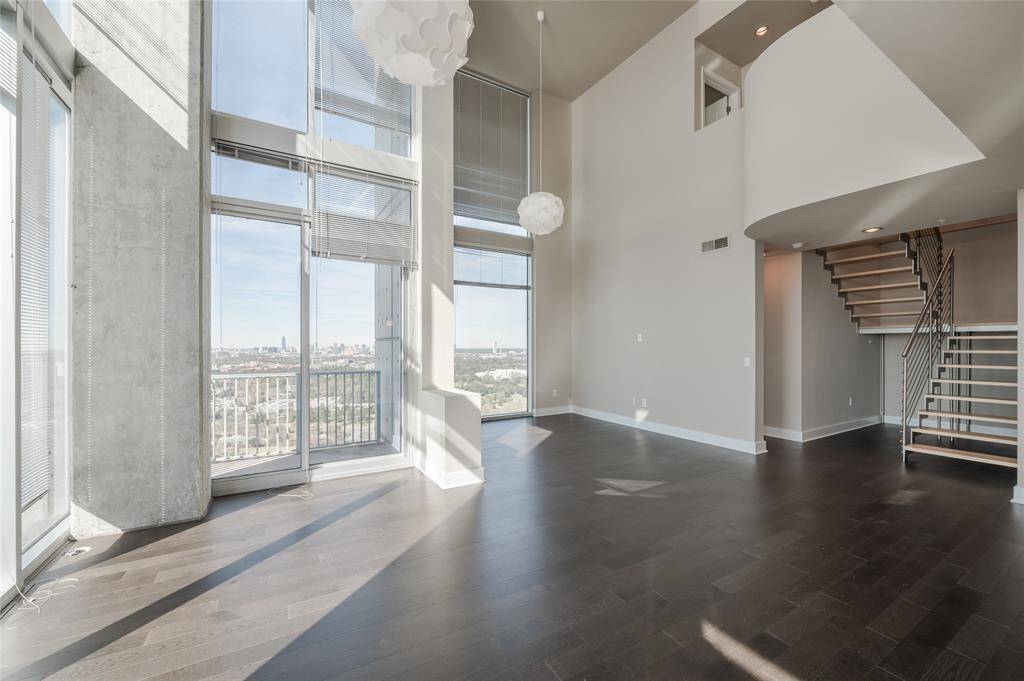 Welcome to this striking double-height penthouse, where urban sophistication meets industrial edge. Located in the heart of the Medical Center, this rare two-story residence makes a statement from the moment you step inside.