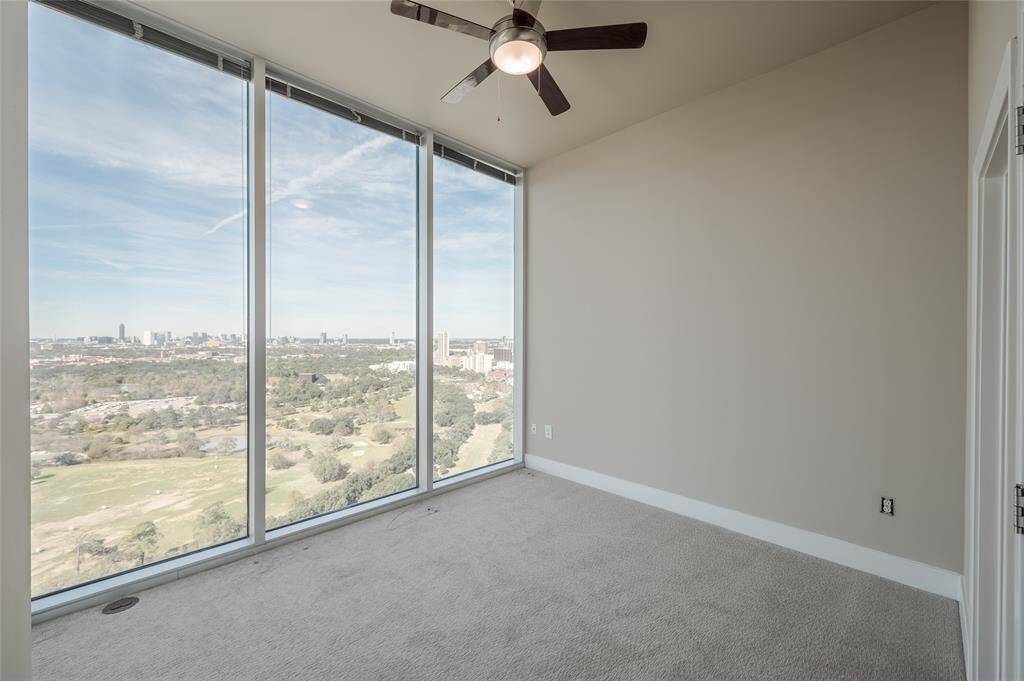 The primary bedroom is a serene escape perched above the city—spacious, dramatic, and infused with minimalist luxury. Set on the upper level, with oversized windows that frame panoramic views of the Medical Center skyline.