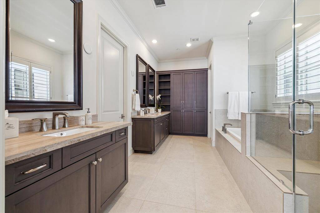 Primary Bath offers dual vanities,walk-in shower and soaking tub.