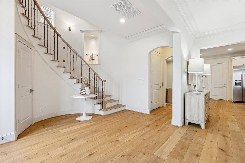 Another view of the large entry. The powder bath door is to the left of the stairway. The elevator dooe is to the right of the stairway.