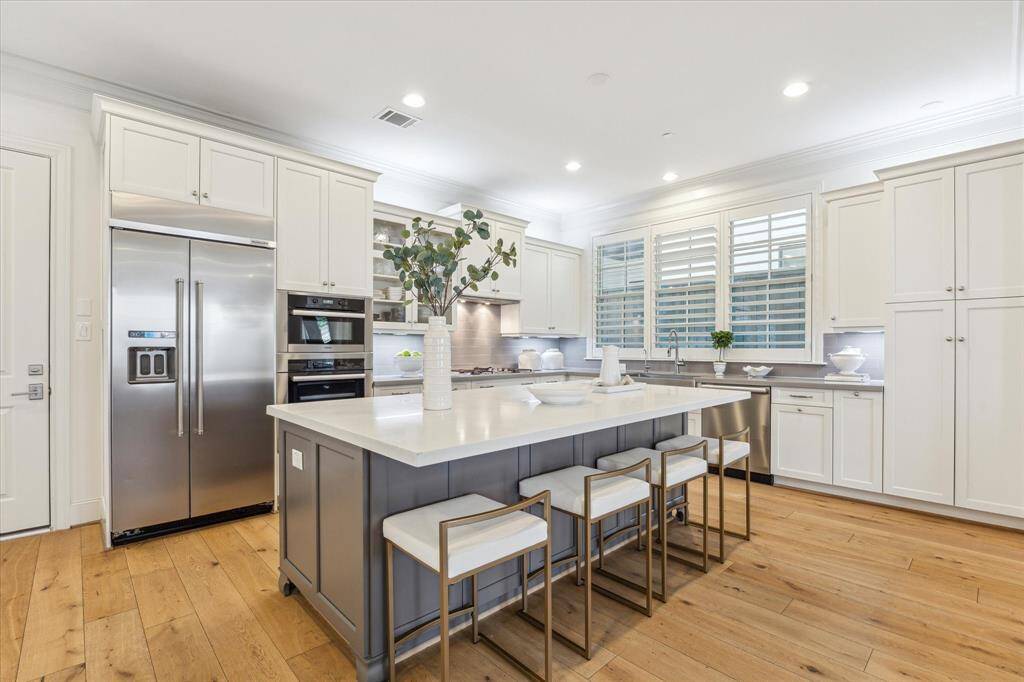 Another view of the kitchen island which offers a large seating space and grand storage.
