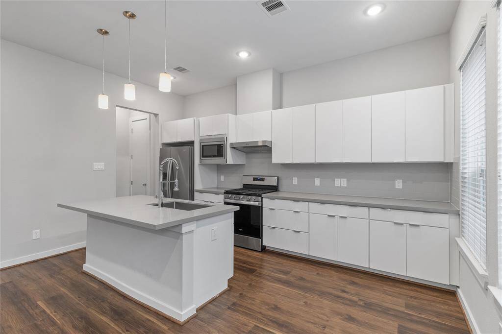 Tons of kitchen cabinets with gas cooktop stove.
