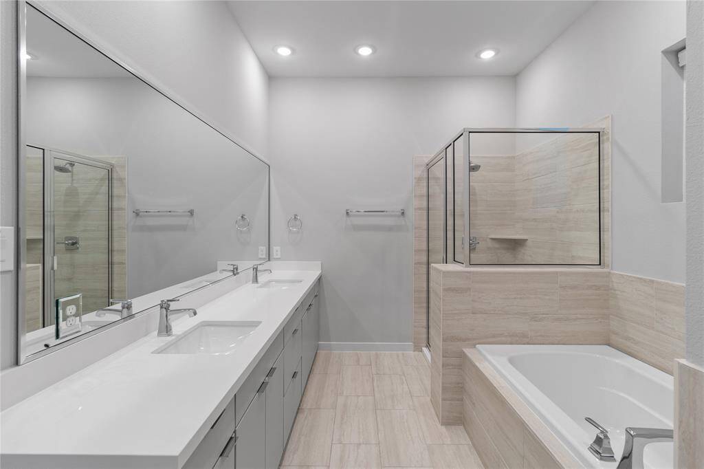 Primary bedroom bathroom with separate walk-in shower and bathtub