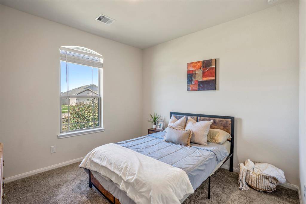 Bright and inviting second bedroom with abundant natural light.