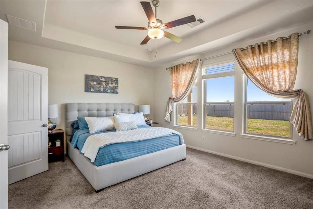 Expansive and elegant primary bedroom offers ample space and comfort.