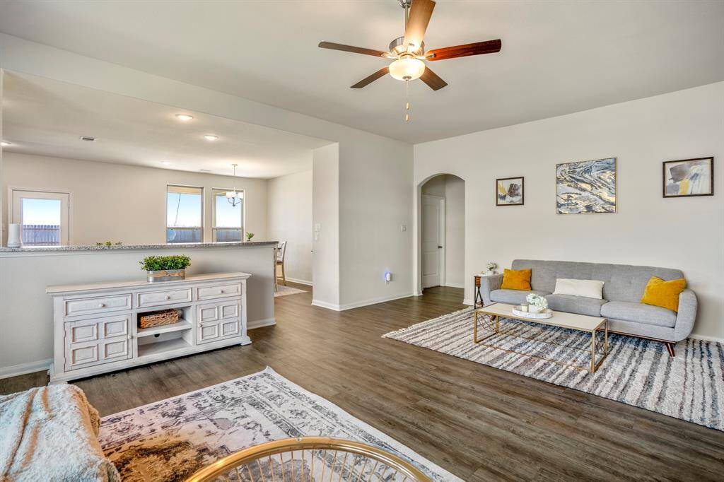 This spacious living room seamlessly flows into the modern kitchen, perfect for entertaining.