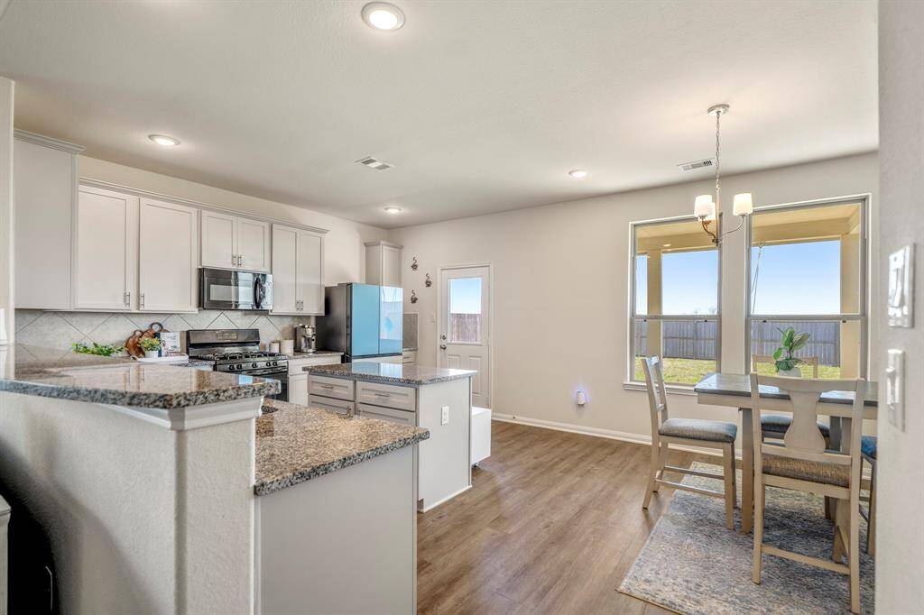 Enjoy seamless indoor-outdoor living with direct kitchen access to the backyard.