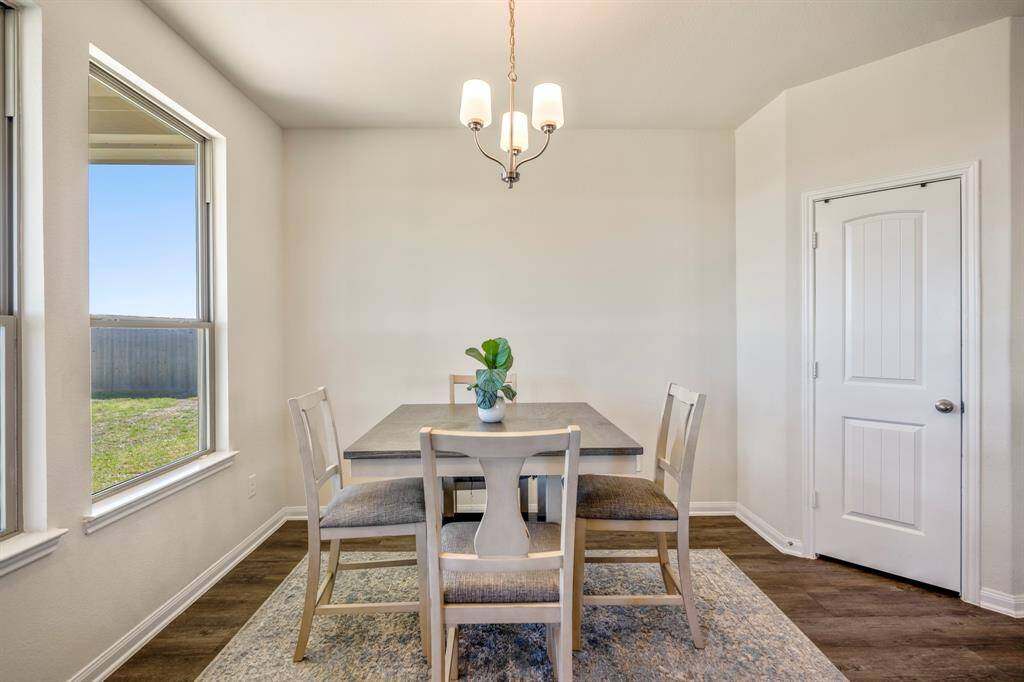 Cozy eat-in kitchen with ample natural light, perfect for casual dining.