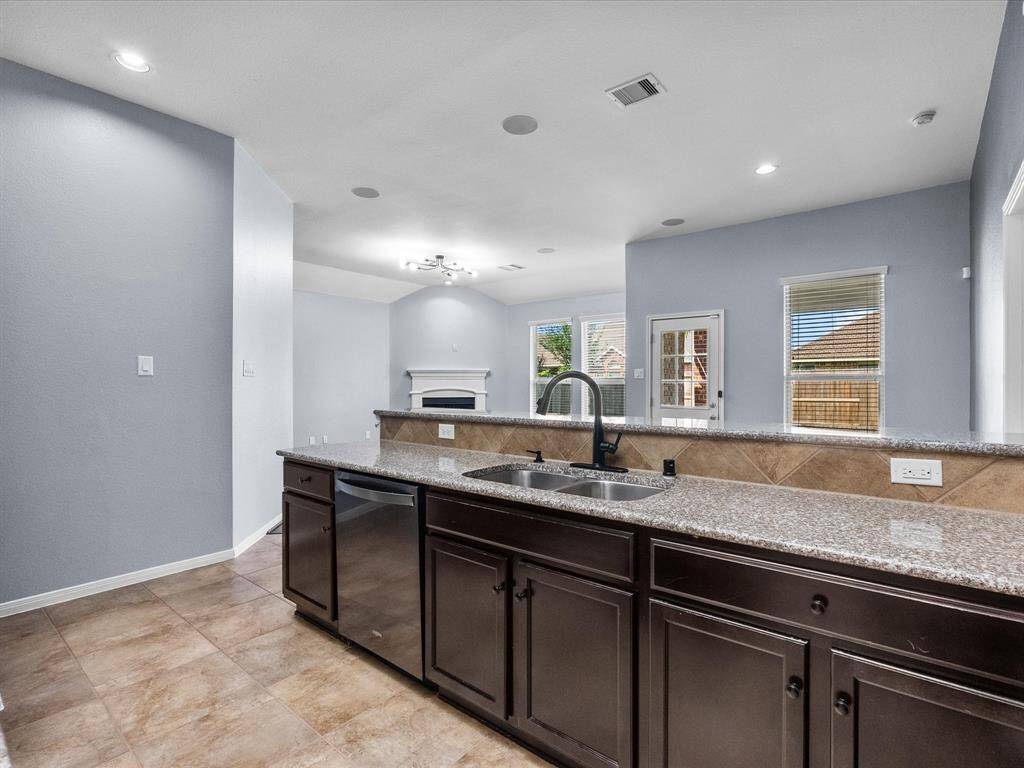 Chef's eat-in island kitchen features lengthy granite countertops, 42" cabinets with crown molding, stainless steel appliances and a breakfast bar. Fridge stays with the home.