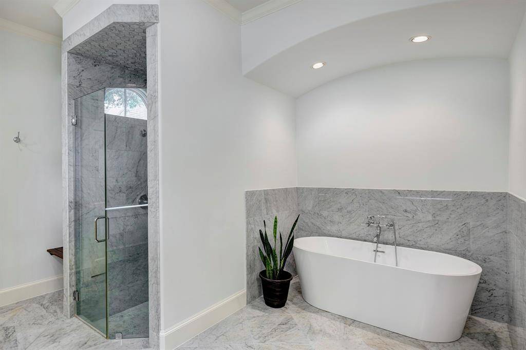 Opulence and serenity in this marble-accented primary bath