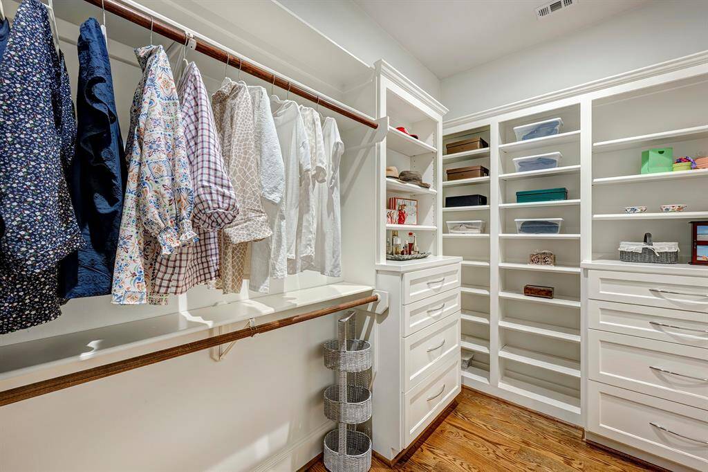 One of two large walk-in closets in the primary bathroom complete with built-ins