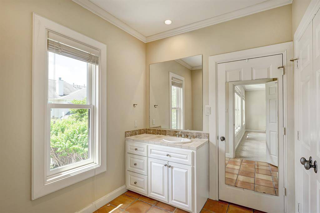 garage apartment bathroom; behind the door is another section with toilet and shower
