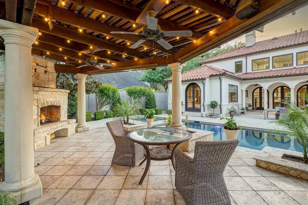 The fireplace anchors this beautiful summer kitchen