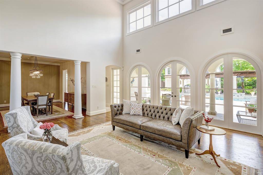 Grand formal living room with exceptionally high ceilings and an abundance of soothing natural light
