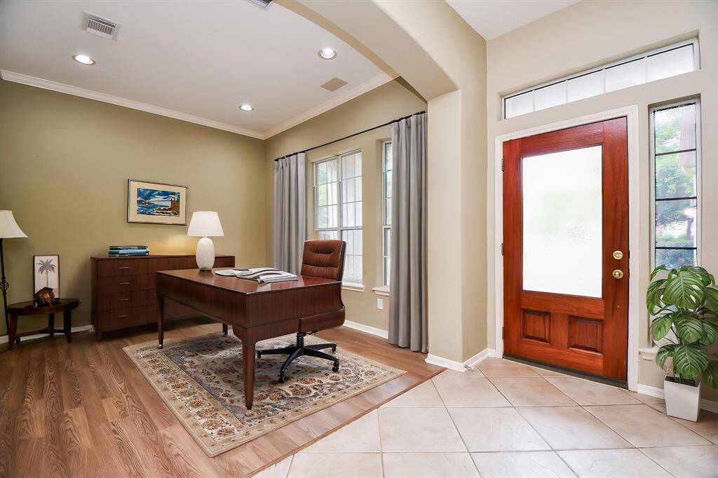 Pale earth toned walls, great natural light, beautiful tile and wood laminate floors, all add up to gentle luxury in this inside view of the front entrance. As suggested, this front room works well as a private home office/study.