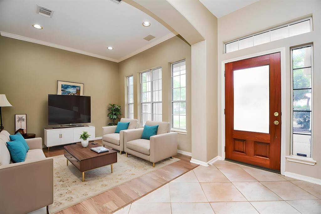 Picture your favorite pieces in this bright front room. Virtually staged